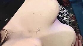 A brunette babe clamps her nipples in close-up detail.