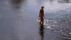 Russian mature woman bathing nude outdoors, revealing her alluring form