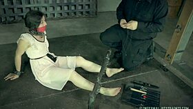 petite brunette endures whipping and bondage with toys in metal restraints