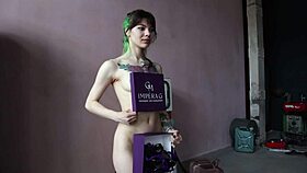 A tattooed model poses nude in a voyeur photoshoot.