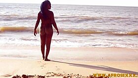 Feeling horny, her big black ass shakes on the beach.