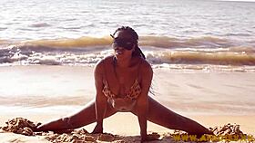 Feeling horny, her big black ass shakes on the beach.