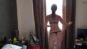 I watch this mature woman twerking erotically on the bed in our hotel room.