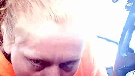 Street whore gives car blowjob with tits and ass exposed.