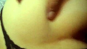 A Latina woman grabs her panties in a playful moment.