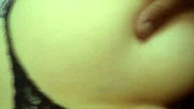 A Latina woman grabs her panties in a playful moment.