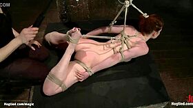 hogtied redhead in a casual bondage scene