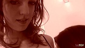 Two friends sit on the sofa sharing stories