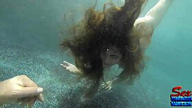 Molly Jane, the seductive mermaid, gets her clothes ripped in an underwater erotic scene.