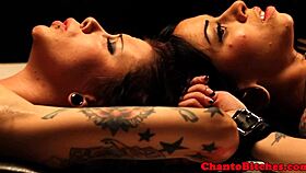 Tied up lesbian lovers in bdsm session with clamps.