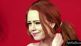 Naughty redheaded beauty enjoys a facial cumshot