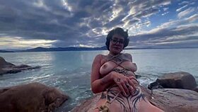 Shibari bondage performed in public with small tits exposed.