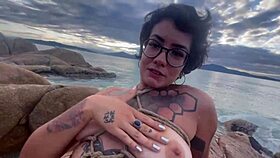 Shibari bondage performed in public with small tits exposed.