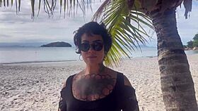 Shibari bondage performed in public with small tits exposed.