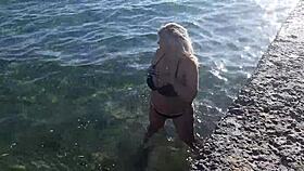 milf teases with candy body on public beach