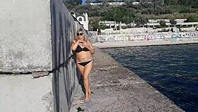 milf teases with candy body on public beach