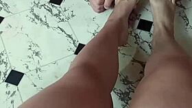 The slave worships his mistress's feet before she tramples and crushes his balls.