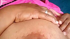 Ebony woman with green eyes and big tits chats casually.