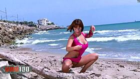 look at this babe stripping by the sea