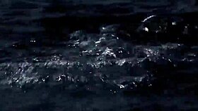 Blonde girl in bikini swims in supernatural setting