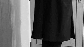 this crossdresser is tying himself up in uniform with handcuffs