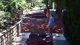 Blonde petite teen April teases with solo masturbation outdoors, fingering her pussy.