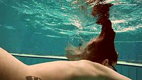 dasha dives underwater in a bikini, revealing her petite naked body by the pool