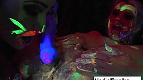 Black-Light Babes Nadia White And Ophelia Suck Off A Colorful Cock?