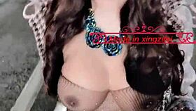 Sexy Chinese shemale Xingzifei shakes cute penis in shiny black stockings outdoors