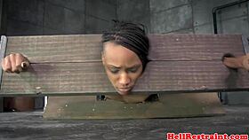 bound black submissive endures whipping and piercing in bdsm punishment