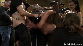 Stunning brunette slut endures public fisting bondage