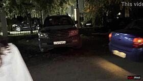 Two girlfriends share a moment peeing by the car in the parking lot