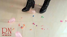 I pop small balloons with my high heels boots on my ass