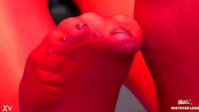 Teasing toes wiggle seductively in red shiny pantyhose.