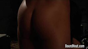 Two bound busty lesbian slaves feel the whip's sting in the garage