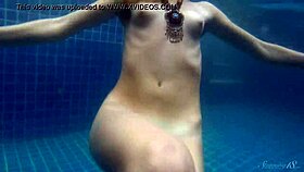 blonde babe wendy strips and swims nude in the pool