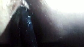 A person explores fisting with a large toy fist in a private session