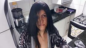 Sensual lady in the kitchen enjoys a moment of relaxation alone quietly