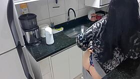 Sensual lady in the kitchen enjoys a moment of relaxation alone quietly