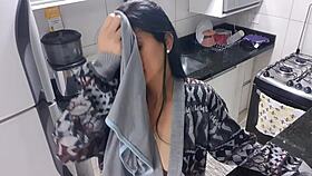 Sensual lady in the kitchen enjoys a moment of relaxation alone quietly