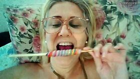 stella still, the blonde milf, sucks a delicious lollipop.