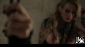 pair of tattooed goth girls share one studded accessory in threesome