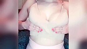 A shy young girl gently reveals her natural body features in a close-up solo session.