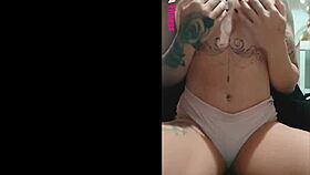 tattooed redhead shows tan lines close up