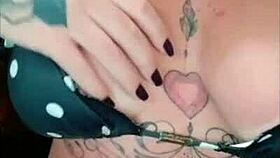 tattooed redhead shows tan lines close up