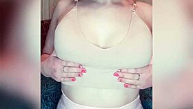 A shy young girl gently reveals her natural body features in a close-up solo session.