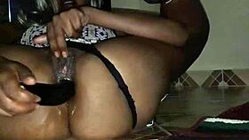 An amateur black mama squirts from eggplant anal, soaking the floor.