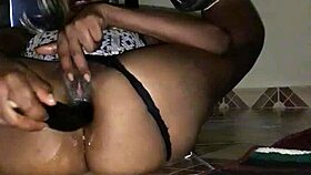 An amateur black mama squirts from eggplant anal, soaking the floor.