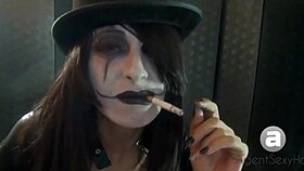 Goth girl shows smoking styles in a fetish setting