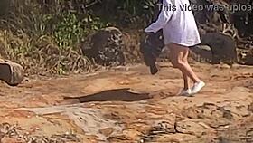a beautiful young girl is WATCHED having sex in public on the beach rocks and INTERRUPTED by a third individual